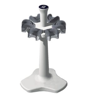 A white, free-standing umbrella holder inspired by the Transferpette S Bench Top Carousel Rack for 6 pipettes (older version, BrandTech), featuring a vertical pole and multiple slots for storing umbrellas on a stable base.