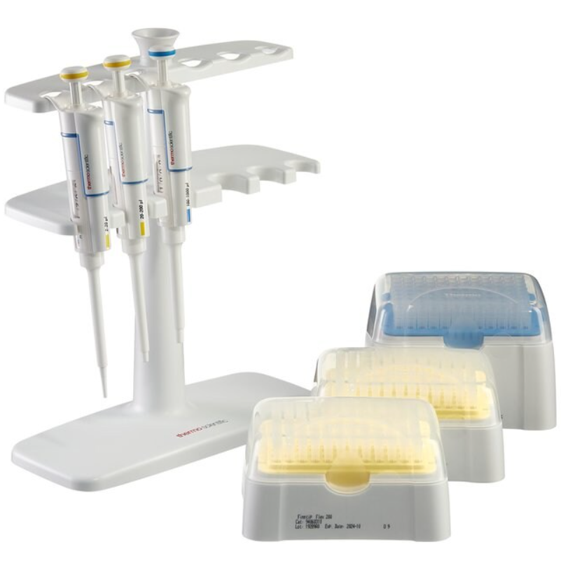 Three Thermo Scientific GLP F1 Kit 4 Finnpipette F1 Single Channel Variable Volume Pipettes (20μL, 200μL, 1000μL) are shown on a white stand, with two yellow tip racks and one blue tip rack nearby.