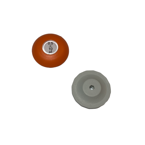 Two round plastic objects on a white background; one is an orange Lambda Plus Push Button, Single Channel, 10μL (Labnet), and the other is a gray single channel part with a central hole.