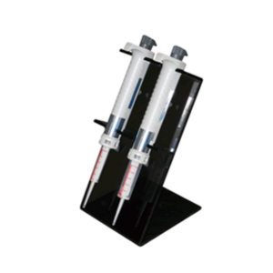 Two laboratory pipettes are upright in a Nichimate Stepper Pipette Stand (Nichiryo), with the Nichimate logo visible, set against a white background.