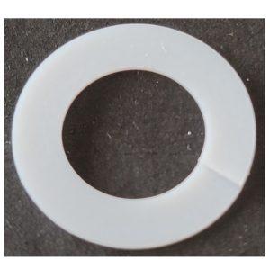 A Nichiryo / Oxford white circular plastic lock washer with a small cut, displayed on a dark background.