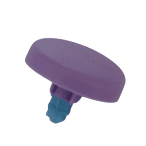 A Picus / Picus NxT Color Push Button, Violet, 1200μL (Sartorius)—a small plastic part with a flat round violet top and short blue stem—is photographed on a white background.