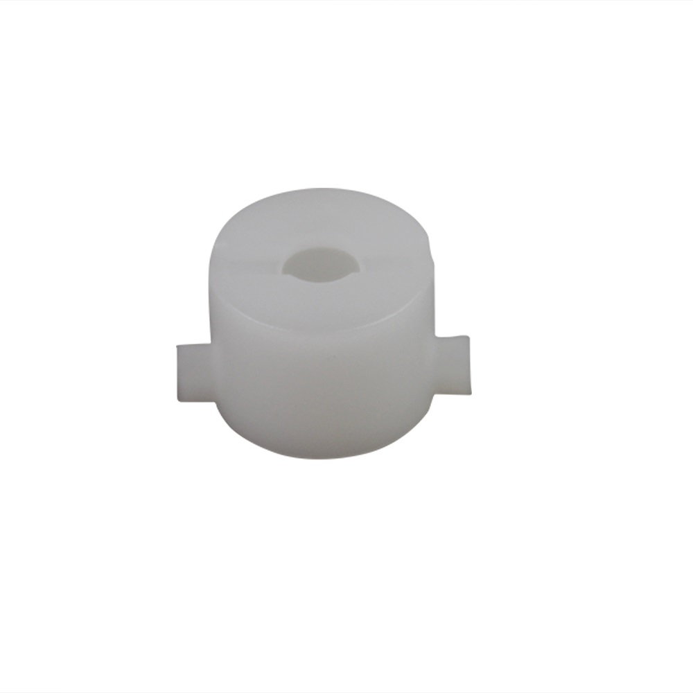 The VWR UHP / Discovery Pro White Fixing Bush (Blowout Spring Locking Bush, Labnet) is a white cylindrical plastic bush with a central hole and two small rectangular tabs, shown against a plain white background.