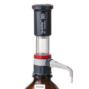 A QuikSip Bottletop Aspirator (BrandTech) is attached to a brown laboratory bottle, featuring a quiksip dispensing spout and a precise control mechanism.