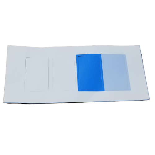 GI F807014 A white sheet with three rectangular cutouts: one holding a bright blue Pipetman M Ejector Side Clip Window Tag (Gilson), another with a light blue tag, and the third cutout left empty.