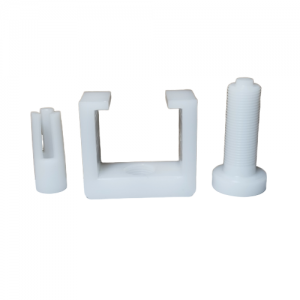 Three white plastic parts—a slotted cylinder, a U-shaped bracket, and a threaded bolt—are lined up on a white background, shown as components of the Gilson Distriman Adjustment Ring Extractor laboratory tool.