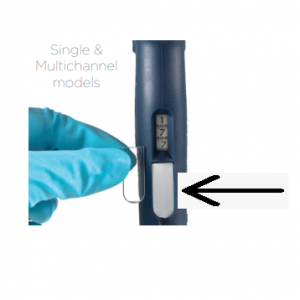 A gloved hand inserts a clear plastic part into a blue Pipetman L Window pipette (Single & Multichannel, All Volumes, 5 Pack by Gilson); an arrow highlights the pipette’s opening. Text: Single & Multichannel models.