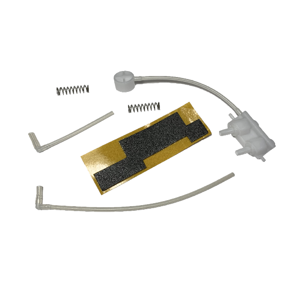GI F1077520 Assorted small mechanical parts from the Macroman, Older Version, Pneumatic Set (Gilson): two springs, plastic tubes, a white plastic piece, and a black-and-gold patterned adhesive strip arranged on a white background.