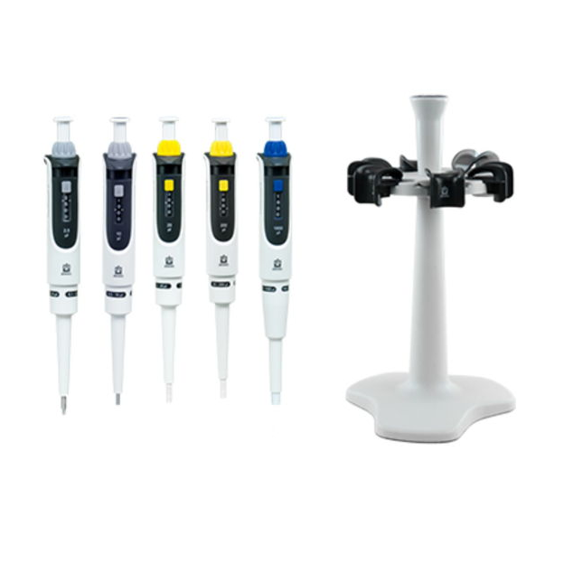 BT 705896 The Transferpette S Pipette Package #1 (BrandTech) displays five adjustable volume pipettes (0.1-2.5μL, 0.5-10μL, 2-20μL, 20-200μL, 100-1000μL) arranged upright beside a white carousel rack for holding pipettes.