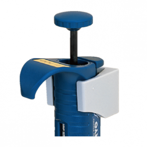 A close-up of the blue Nichiryo micropipette shows its thumb plunger, side volume knob, and a secure Nichiryo Pipette Holder (Nichiryo) for convenient storage.