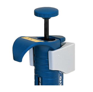 A close-up of the blue Nichiryo micropipette shows its thumb plunger, side volume knob, and a secure Nichiryo Pipette Holder (Nichiryo) for convenient storage.