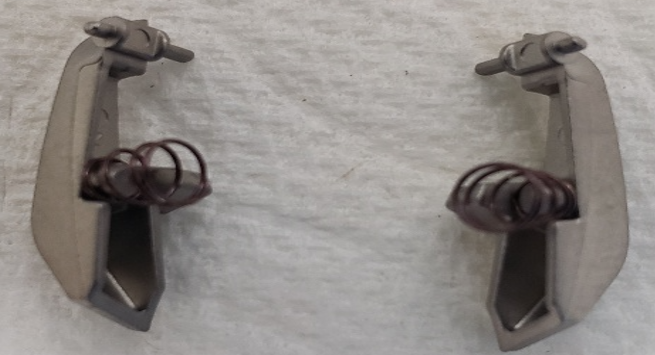 Installed spring on volume catch