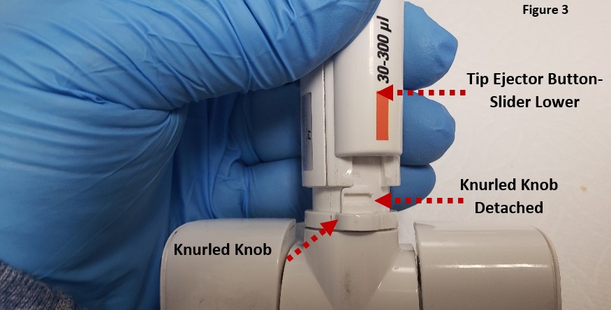 Rotate and detach the tip ejector assembly