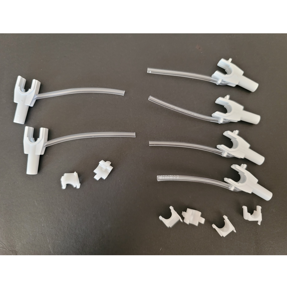 Six Rainin Nozzle Sets with Tubing, Adjustable Spacer Multichannel, 6 Channel, 300μL, are arranged on a black surface alongside six small plastic components.