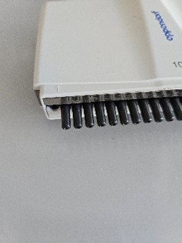 Broken Nose Cone on an Eppendorf Research Plus pipette, placed on a light surface.