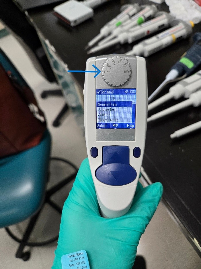 A gloved hand holds an Eppendorf Xplorer electronic pipette with a display screen, surrounded by pipettes and lab equipment on a lab bench, illustrating precision with Eppendorf Xplorer Adjustment in the laboratory setting.